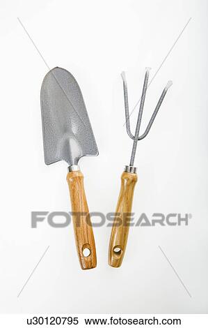 Stock Photography - Hand held spade and gardening fork. Fotosearch