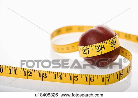 Measuring tape wrapped around nectarine. View Large Photo Image Stock Photograph - Measuring tape wrapped around nectarine.. Fotosearch