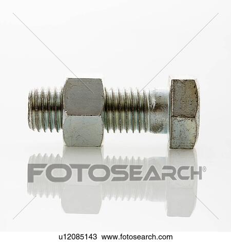 Stock Image - Nut and bolt against white background.. Fotosearch