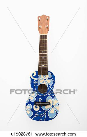 Stock Image - Ukulele painted with blue flowers in Hawaiian pattern.. Fotosearch