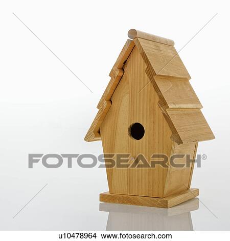 Picture - Wooden birdhouse against white background.. Fotosearch