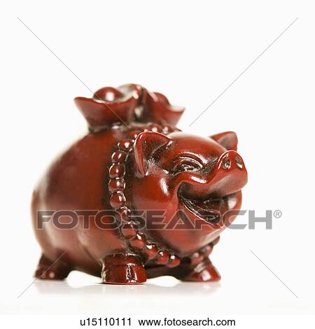 Stock Image - Chinese pig figurine on white background.. Fotosearch