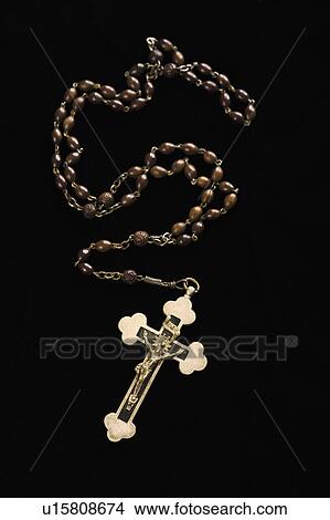 Picture - Christian rosary beads with crucifix on black background. Fotosearch