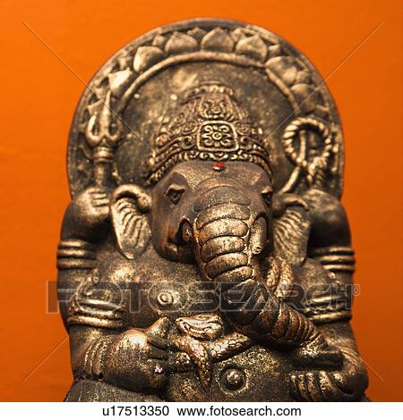Statue of Hindu elephant Ganesha against orange wall. View Large Photo Image Stock Image - Statue of Hindu elephant Ganesha against orange wall.. Fotosearch