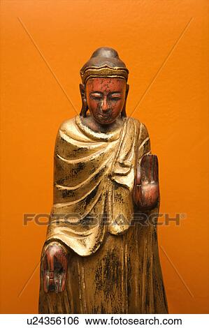 Stock Photograph - Wooden Buddha statue. Fotosearch