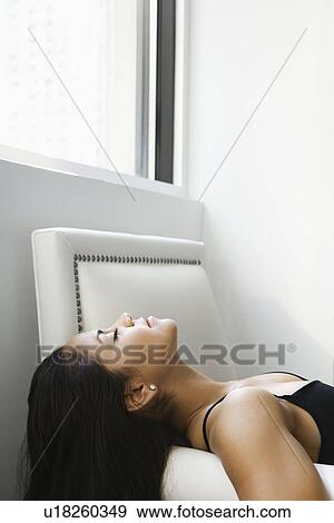 Profile of young adult woman lying on her back with eyes closed. View Large Photo Image Stock Photo - Profile of young adult woman lying on her back with eyes closed.. Fotosearch