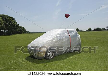 Stock Photograph - Bubble wrapped car with balloons. Fotosearch