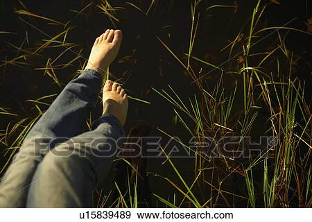 Stock Photo - Legs over pond.. Fotosearch