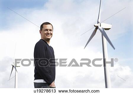 Man on wind farm View Large Photo Image Stock Image - Man on wind farm. Fotosearch