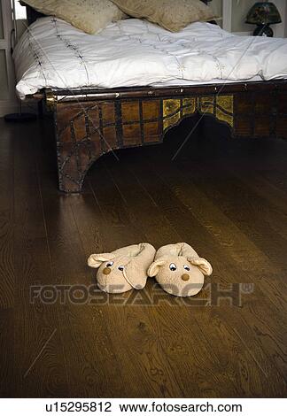Stock Image - Slippers on bedroom floor.. Fotosearch