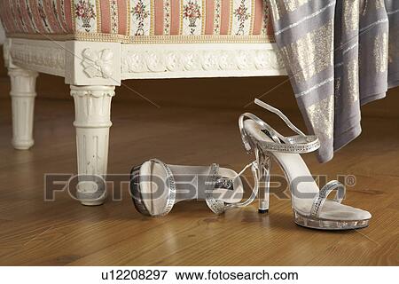 two silver high-heeled womans sandals on wooden floor, close-up View Large Photo Image Stock Photo - two silver high-heeled womans sandals on wooden floor, close-up. Fotosearch