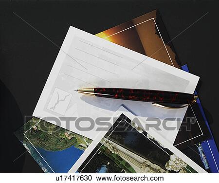 Stock Image - Vacation postcards and pen on table. Fotosearch