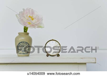 Antique clock and flower in vase View Large Photo Image Stock Photo - Antique clock and flower in vase. Fotosearch