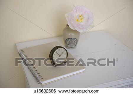 Antique clock and notebook on cabinet View Large Photo Image Stock Photograph - Antique clock and notebook on cabinet. Fotosearch