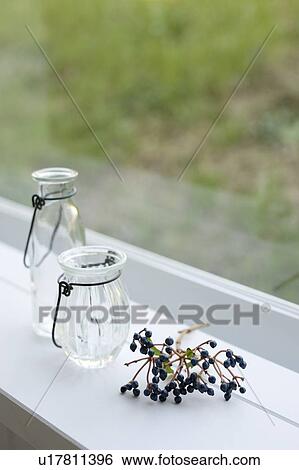 Stock Photograph - Empty bottles by window. Fotosearch