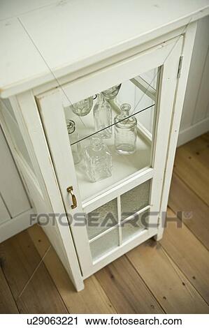 Stock Image - Empty bottles in cabinet. Fotosearch