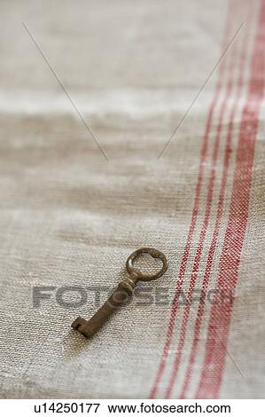 Stock Photo - Old key on fabric. Fotosearch