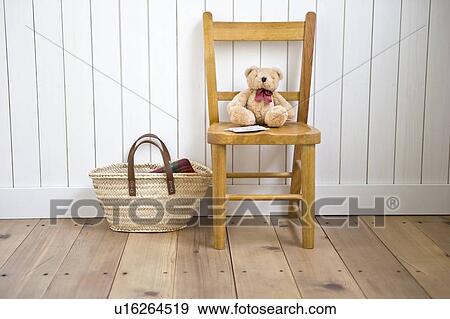 Stock Photo - Stuffed animal on chair. Fotosearch