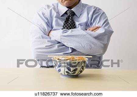 Businessman sitting in front of food View Large Photo Image Stock Photo - Businessman sitting in front of food. Fotosearch