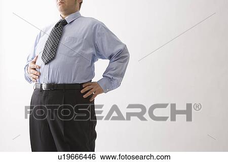 Stock Photograph - Businessman touching his belly. Fotosearch