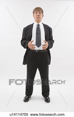 Businessman touching his belly View Large Photo Image Stock Photography - Businessman touching his belly. Fotosearch