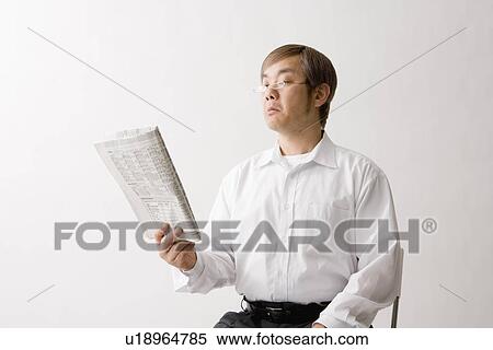 Stock Photography - Mature man reading newspaper. Fotosearch