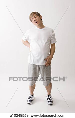 Stock Image - Mid adult man exhausted. Fotosearch