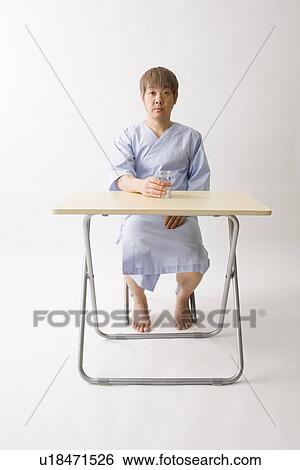 Stock Photograph - Mid adult man holding a glass of water. Fotosearch