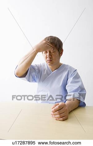 Mid adult man suffering from headache View Large Photo Image Stock Photography - Mid adult man suffering from headache. Fotosearch