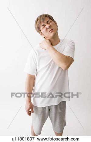 Stock Photo - Mid adult man suffering from pain. Fotosearch