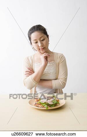 Mid adult woman looking at pizza View Large Photo Image Stock Photo - Mid adult woman looking at pizza. Fotosearch