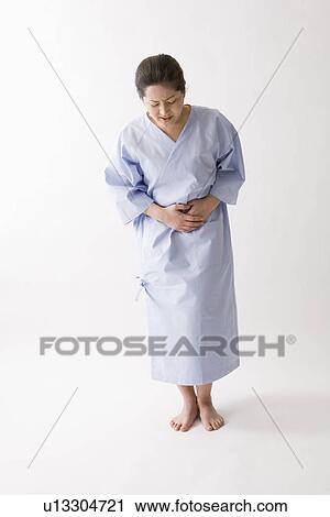 Mid adult woman suffering from abdominal pain View Large Photo Image Stock Image - Mid adult woman suffering from abdominal pain. Fotosearch