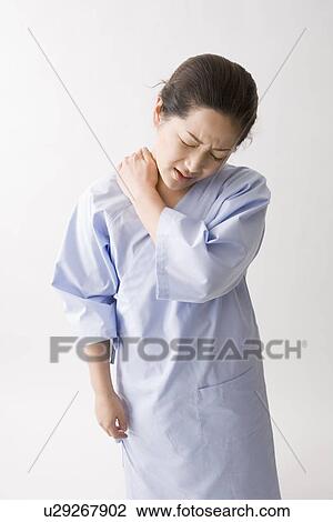 Mid adult woman suffering pain in shoulder View Large Photo Image Stock Image - Mid adult woman suffering pain in shoulder. Fotosearch