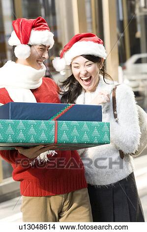 Picture - Japanese young couple enjoy shopping. Fotosearch
