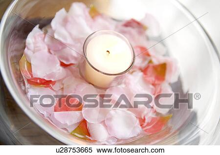 Stock Photography - Candle floating in the water of a bowl. Fotosearch