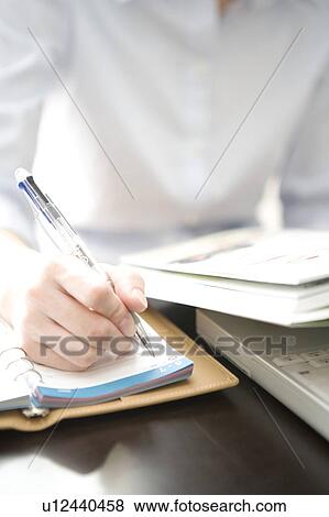 Stock Photo - Hand taking note. Fotosearch