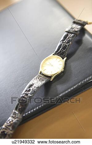 Stock Image - Notebook and a watch. Fotosearch