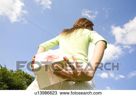 Woman having a present View Large Photo Image Stock Image - Woman having a present. Fotosearch