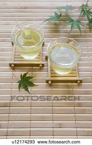 Stock Image - Green tea and maple leaf. Fotosearch