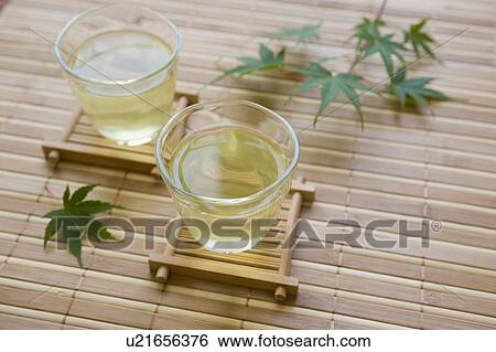 Stock Photograph - Green tea and maple leaf. Fotosearch