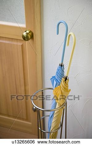 Stock Photograph - Umbrella and umbrella stand in front of door. Fotosearch