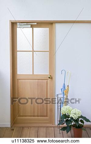 Umbrella stand and hydrangea in front of door View Large Photo Image Stock Photography - Umbrella stand and hydrangea in front of door. Fotosearch