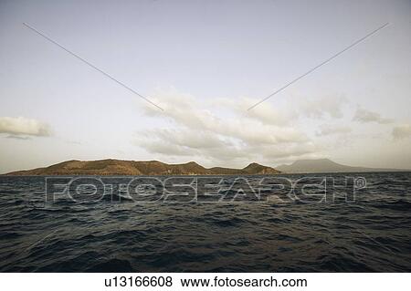 Clouds over mountains along the sea View Large Photo Image Stock Photo - Clouds over mountains along the sea. Fotosearch