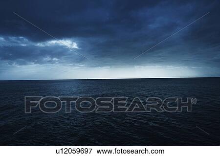 Stock Photo - Clouds over the sea. Fotosearch