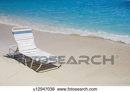 High angle view of a lounge chair on the beach View Large Photo Image Stock Photo - High angle view of a lounge chair on the beach. Fotosearch