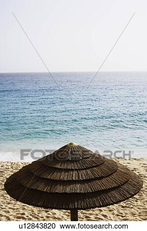 Stock Image - High angle view of a palapa on the beach. Fotosearch