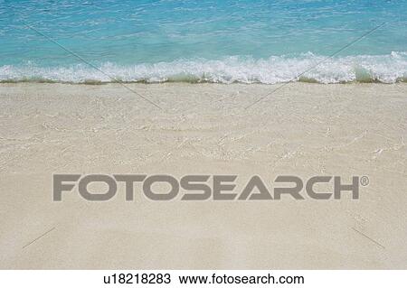 High angle view of waves breaking on the beach View Large Photo Image Stock Image - High angle view of waves breaking on the beach. Fotosearch
