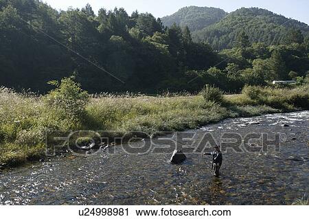 Stock Image - "Fishing In A River, Nagano, Japan". Fotosearch