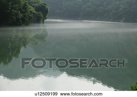 Stock Photo - "Reflection Of Forest On River, Nagano, Japan". Fotosearch