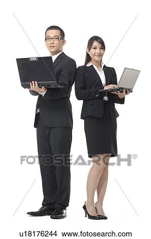 Businessman and a businesswoman working on laptops View Large Photo Image Picture - Businessman and a businesswoman working on laptops. Fotosearch
